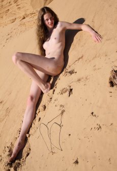 Худенькая голая девушка Nicole на песке